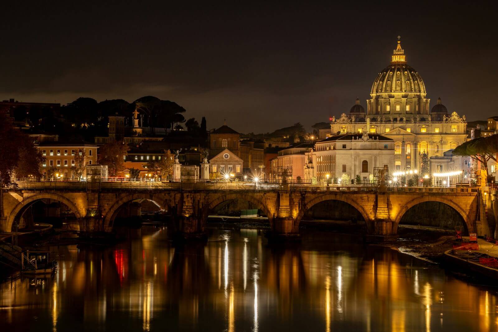 A bridge over a body of water at night